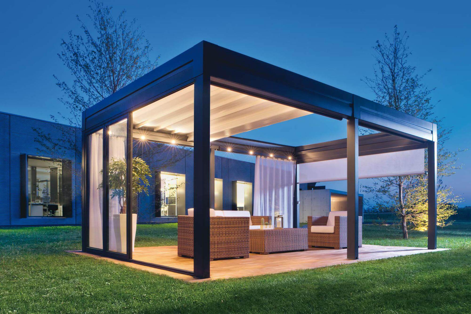 Illuminated free-standing pergola with a partially retracted cover