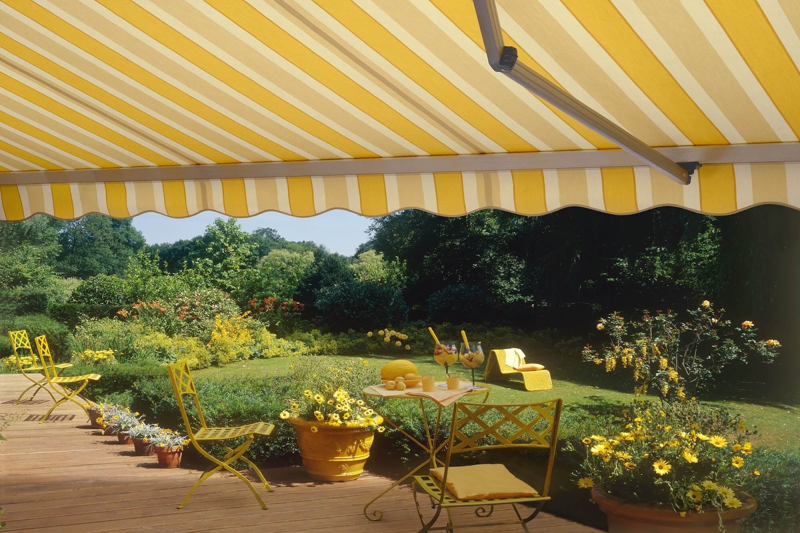 Lemon-striped folding retractable canopy overlooking a garden