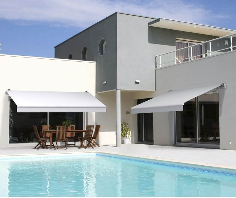 Two light grey retractable covers by a pool