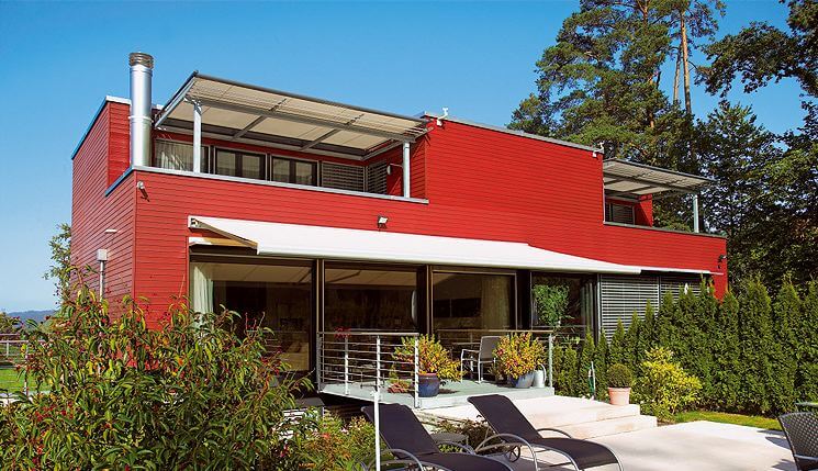 Retractable awning on a red house