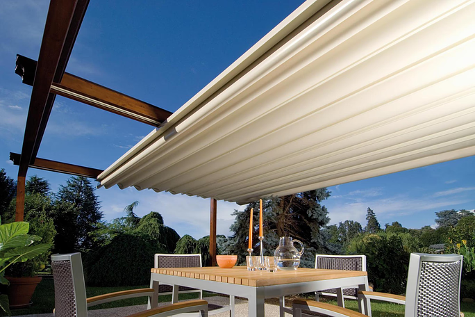 Wood and veneer laminated aluminum frame retractable pergola protecting outdoor dining set